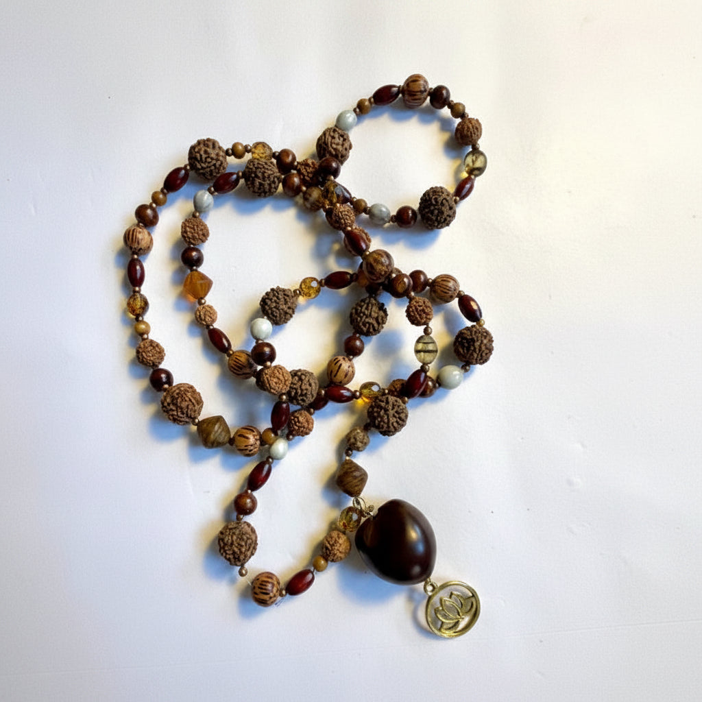 Mala bead necklace, polished wooden beads, bean beads and a unique Buddha pendant