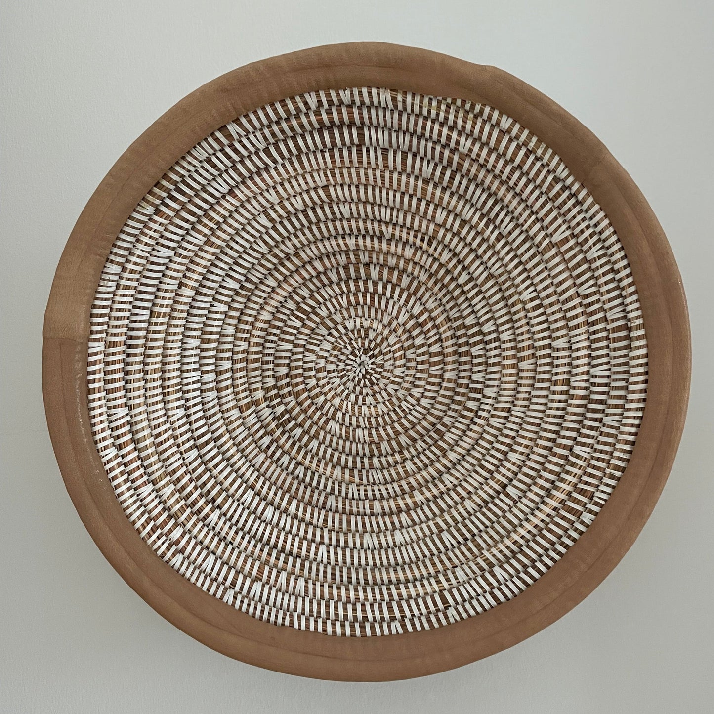 Wicker baskets for wall or table. Braided in elephant grass with leather or textile edging. Fair Trade from Senegal
