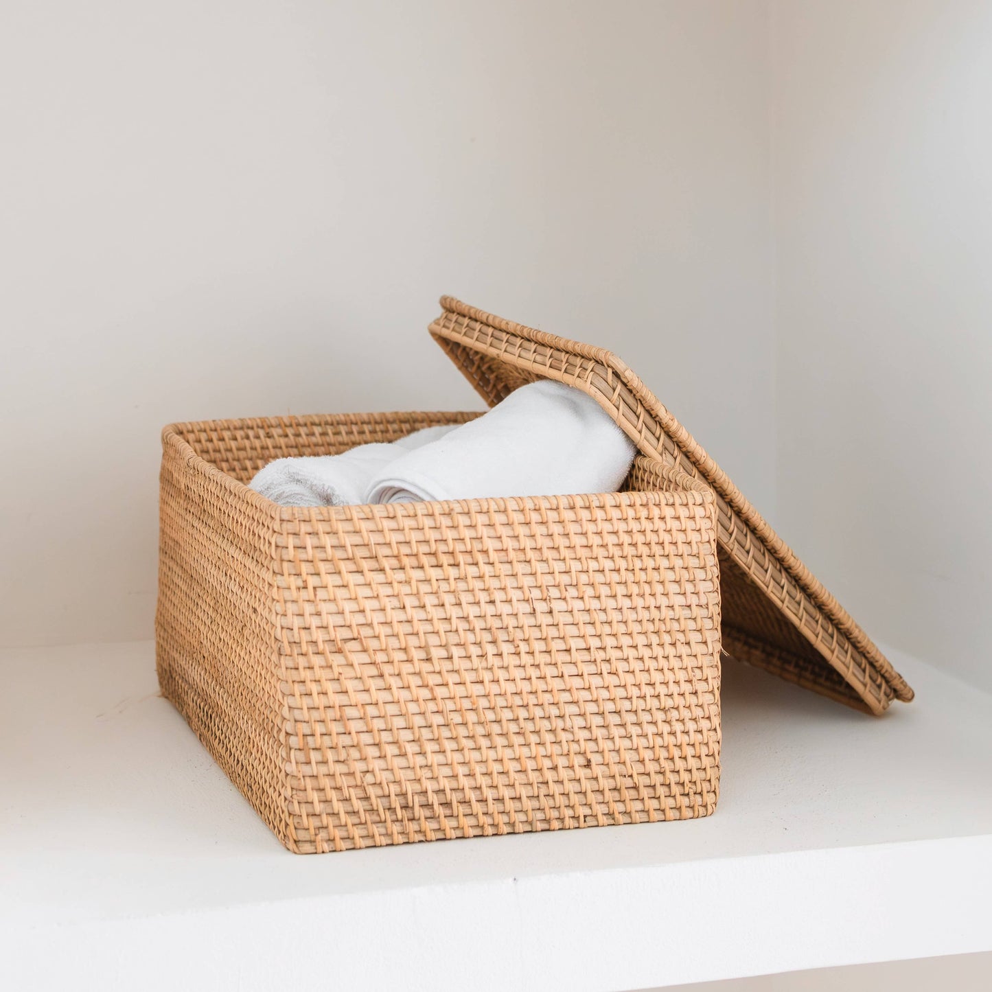 Storage basket with lid in light rattan