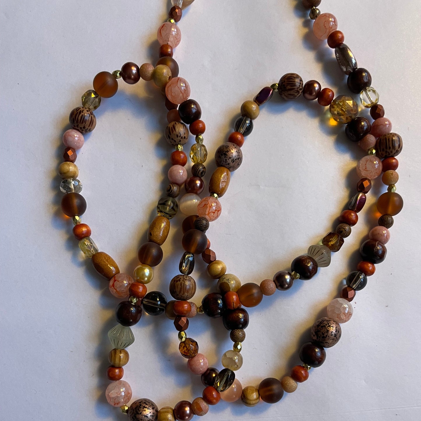 Mala bead necklace, polished wooden beads, bean beads and a unique Buddha pendant