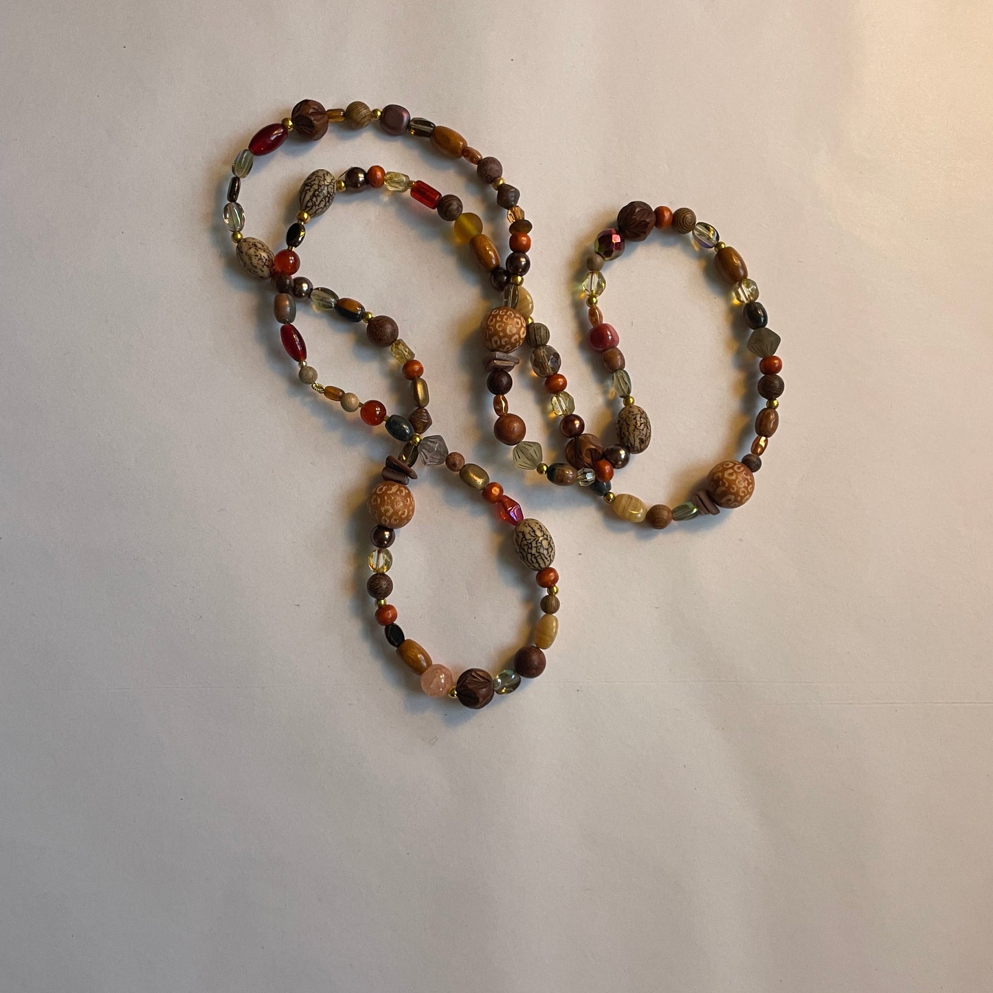 Mala bead necklace, polished wooden beads, bean beads and a unique Buddha pendant