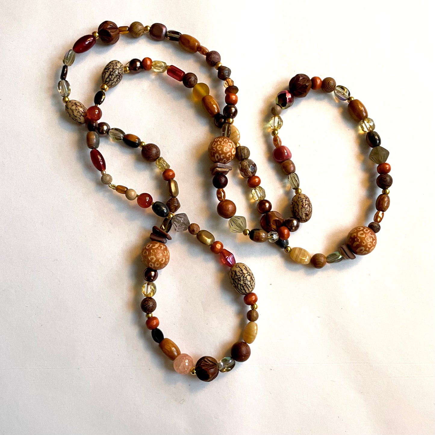 Mala bead necklace, polished wooden beads, bean beads and a unique Buddha pendant