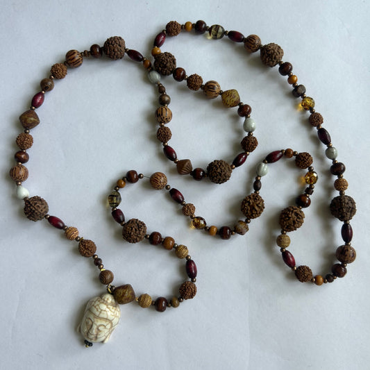 Mala bead necklace, polished wooden beads, bean beads and a unique Buddha pendant