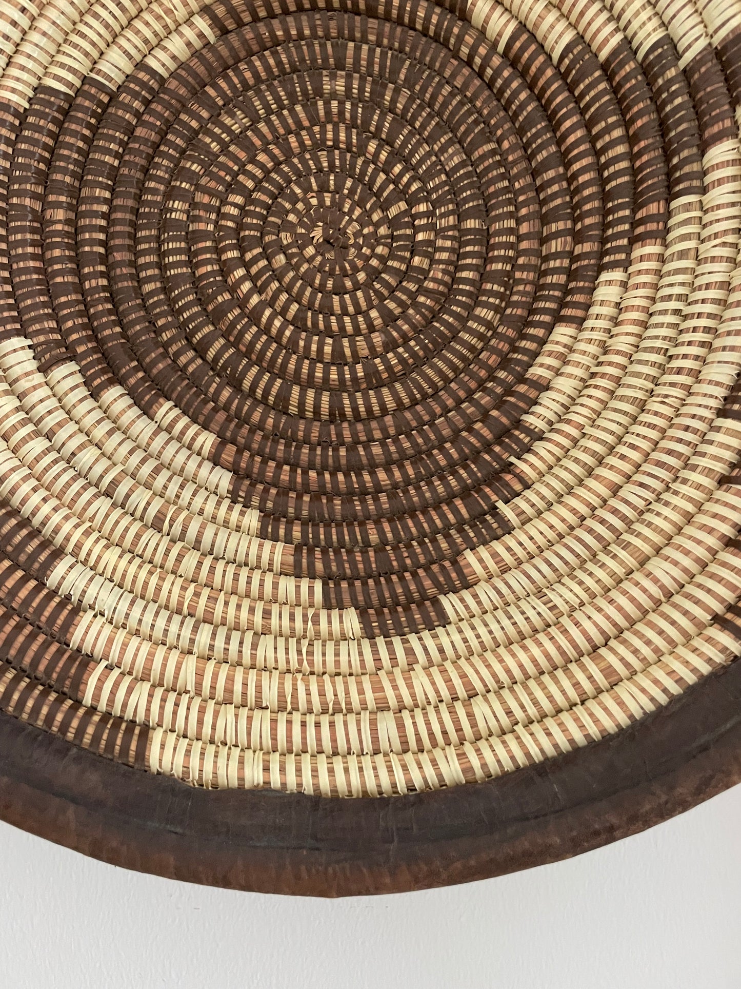 Wicker baskets for wall or table. Braided in elephant grass with leather or textile edging. Fair Trade from Senegal