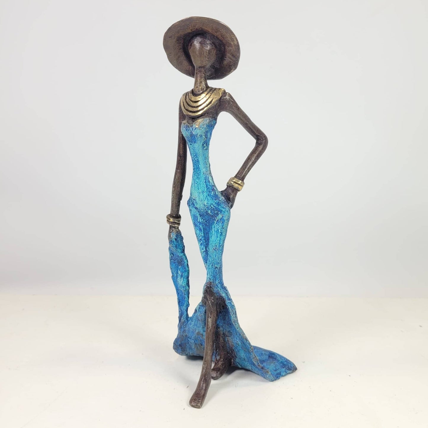 Kvinde med bog og hat – bronzeskulptur af den burkinske kunstner Soré, blå kjole, str. 16 cm